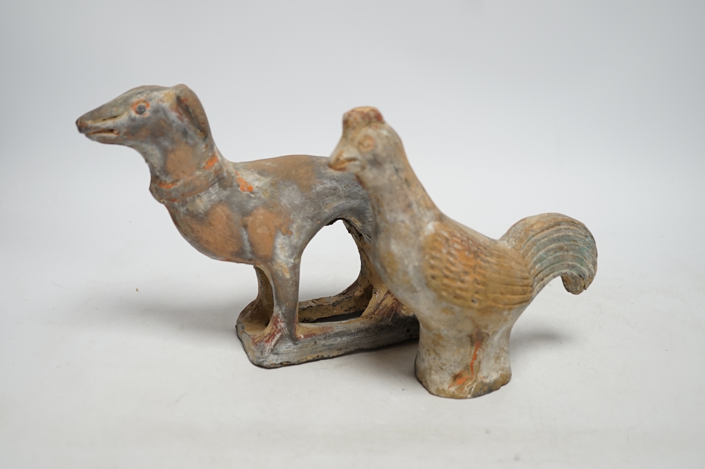 Two Chinese pigment painted figures of a cockerel and a dog, Han dynasty or later, 17cm